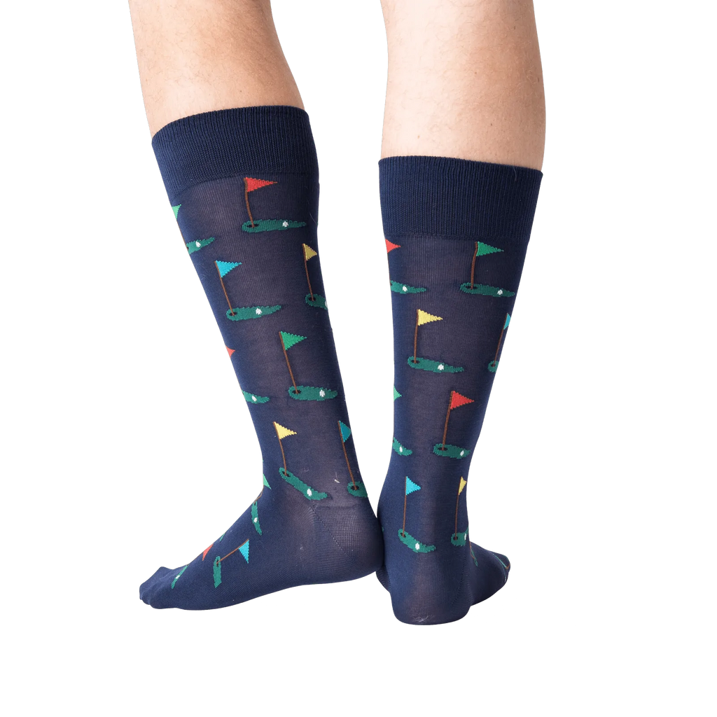 Navy blue socks with colorful geometric pattern worn by a person on a white background