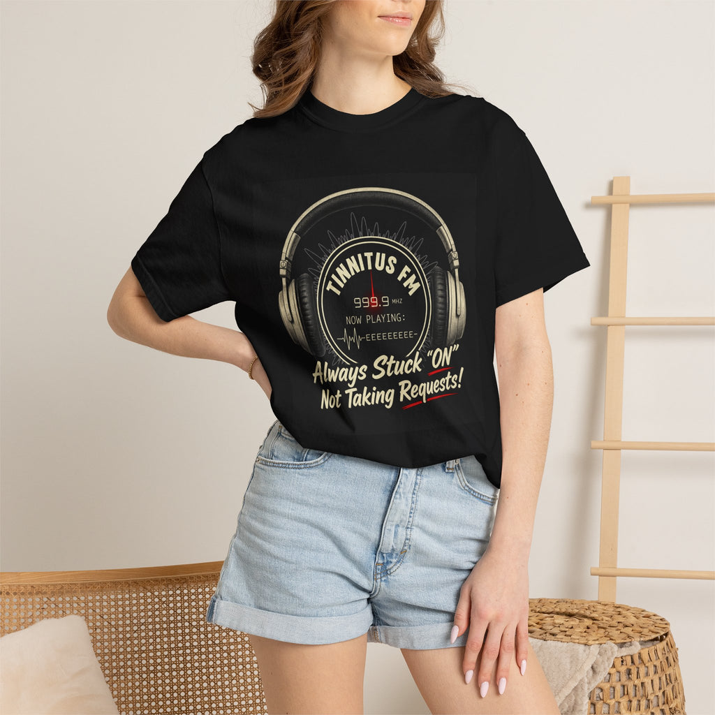 Person wearing a black t-shirt with a graphic design of a duck and text, standing against a neutral background.