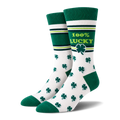 A pair of white crew socks with green toes, heels, and cuffs, decorated with green shamrocks and a green band that reads '100% LUCKY' with a shamrock, set against a plain white background.