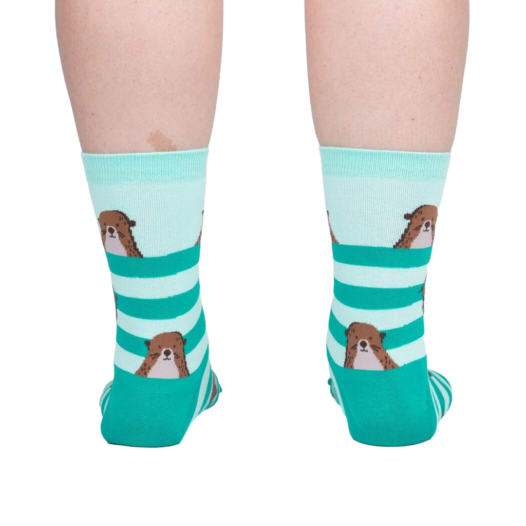 Teal and white striped socks with dog illustrations worn by a person on a white background