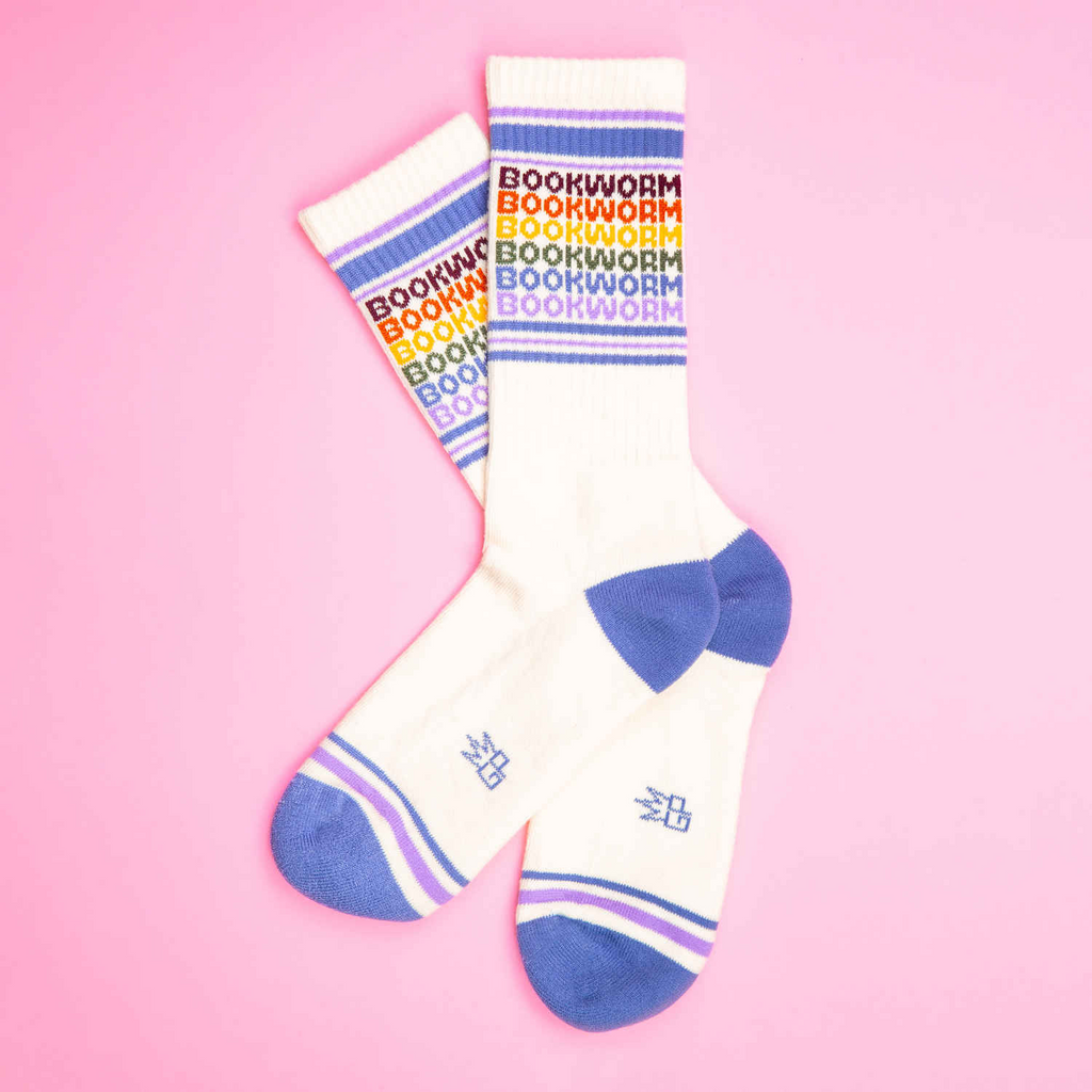 White socks with colorful 'bookworm' text and blue accents on a pink background