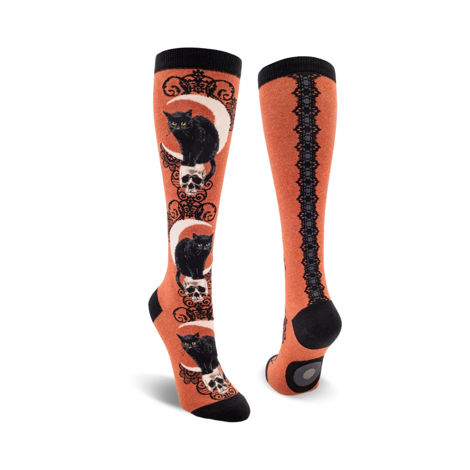 Pair of knee-high socks with black cat and skull design on an orange background