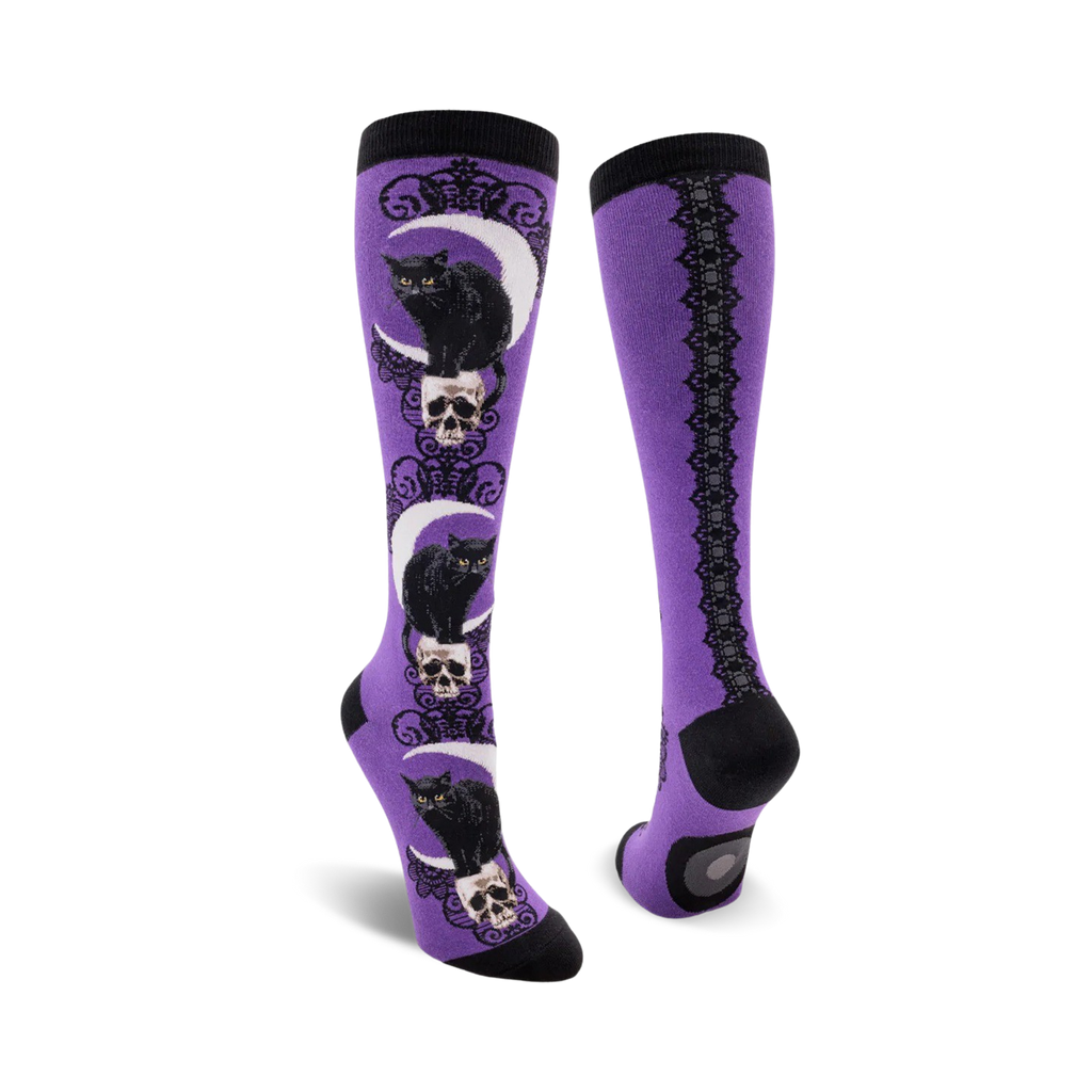 Purple knee-high socks with black cat and skull design on a white background
