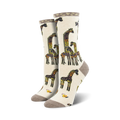 A pair of knee-high socks with a cream background featuring a pattern of giraffes and a small yellow bird. The socks have brown heels, toes, and cuffs, and are displayed on a clean white background.
