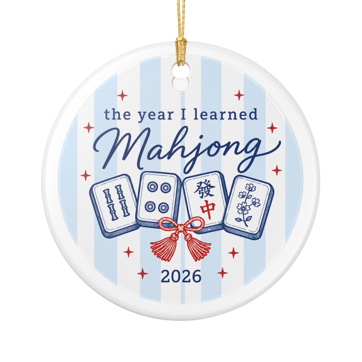 A round white ceramic ornament featuring a light blue and white striped background with the text 'the year I learned Mahjong 2026' and illustrations of four mahjong tiles tied with a red bow.