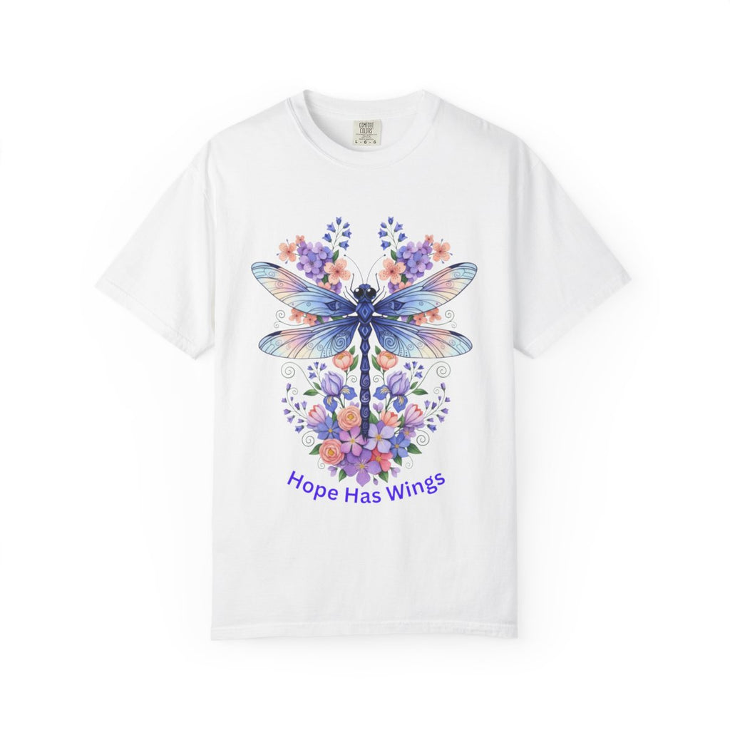 A white short-sleeve crewneck t-shirt featuring a colorful graphic of a dragonfly surrounded by purple and orange flowers, with the text 'Hope Has Wings' printed below in purple, displayed on a clean white background.