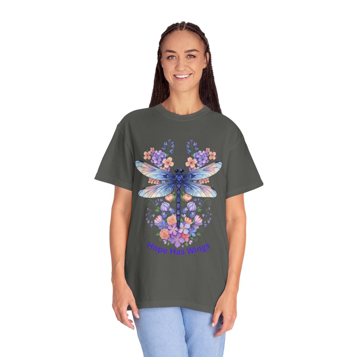 A woman modeling a dark gray t-shirt with a colorful butterfly and floral graphic on the front, paired with light blue jeans, against a plain white background.