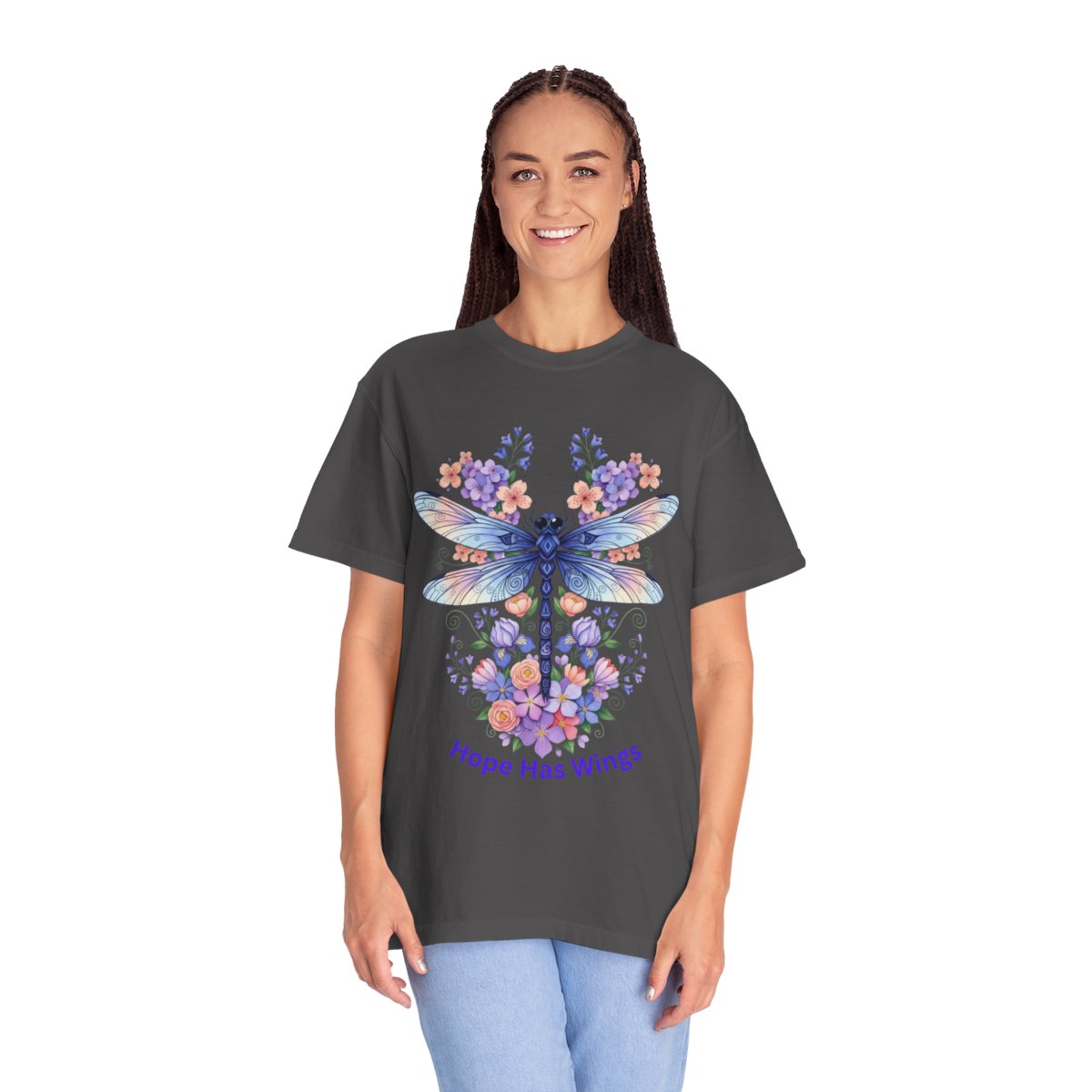 A woman modeling a dark charcoal gray t-shirt with a colorful graphic of a blue dragonfly surrounded by purple and pink forget-me-nots, with the text 'Hope Has Wings' printed below.