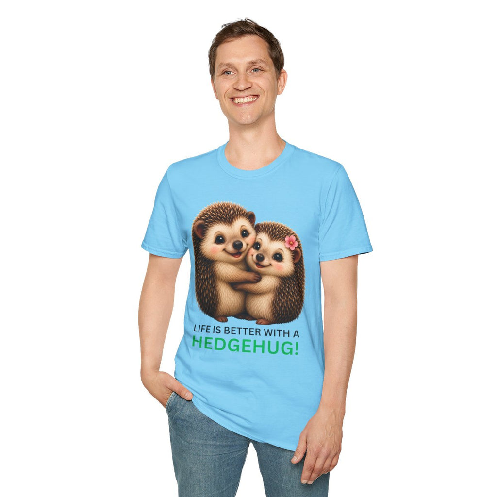 A man wearing a light blue t-shirt with a graphic of two hugging hedgehogs and the text 'LIFE IS BETTER WITH A HEDGEHUG!' in green and brown, paired with blue jeans against a plain white background.