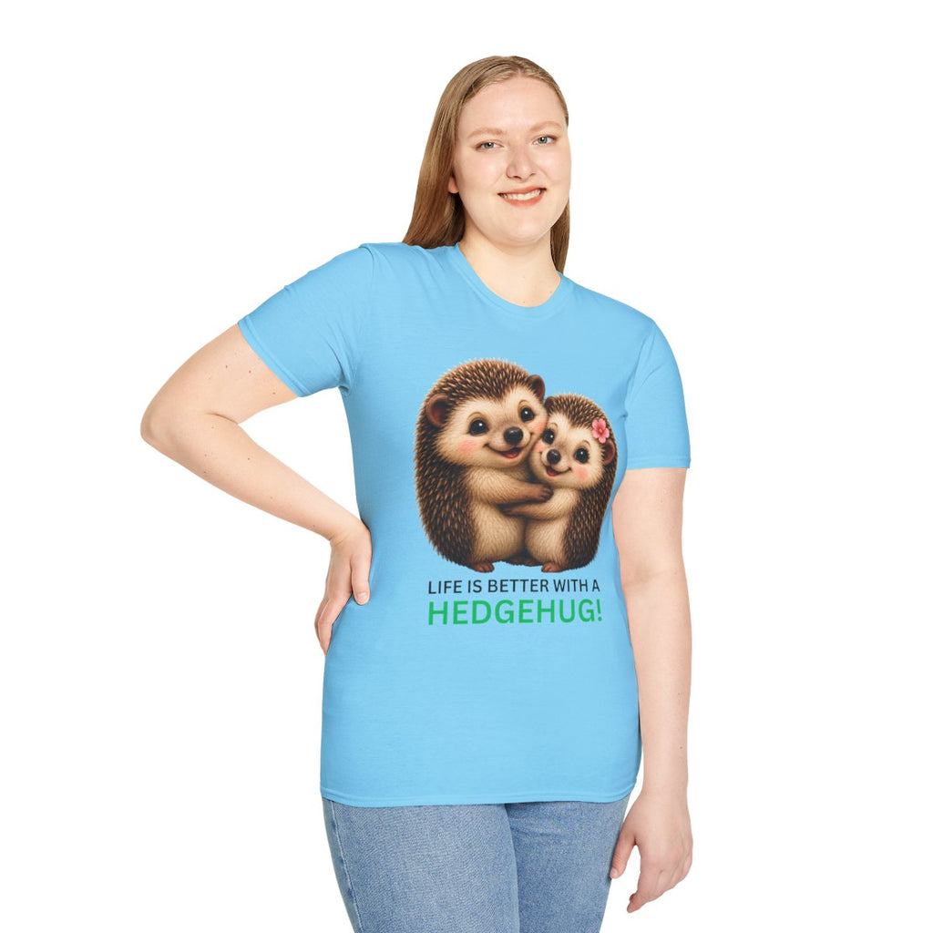 A woman modeling a light blue short-sleeve t-shirt with a graphic of two hedgehogs hugging and the text 'LIFE IS BETTER WITH A HEDGEHUG!' printed on the front, set against a plain white background.