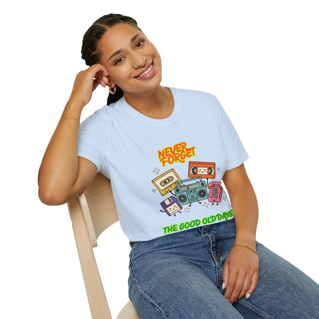 A woman sitting on a wooden chair wearing a light blue graphic t-shirt with retro cassette tapes and the text 'NEVER FORGET' and 'THE GOOD OLD DAYS'.