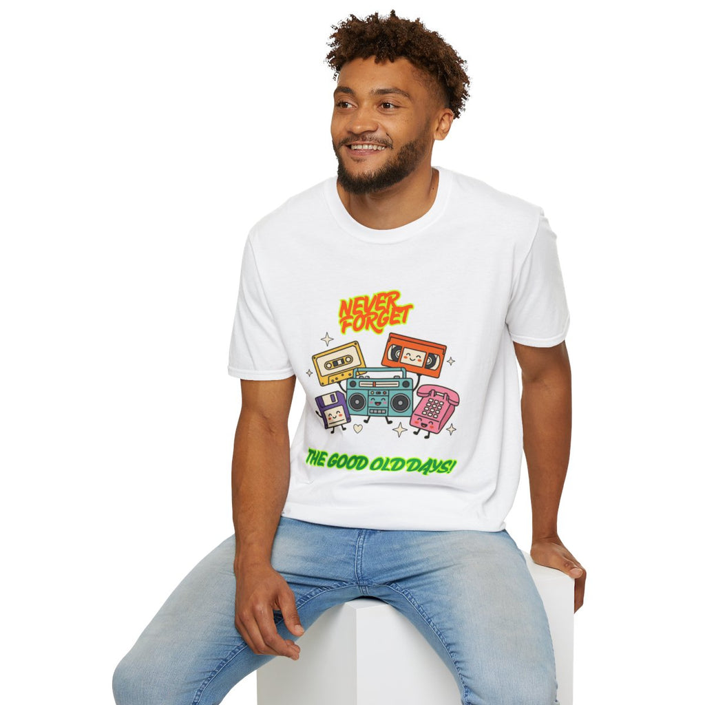 A man wearing a white graphic t-shirt with a retro cassette tape design and the text 'Never Forget The Good Old Days!', paired with light blue jeans, sitting on a white block against a white background.