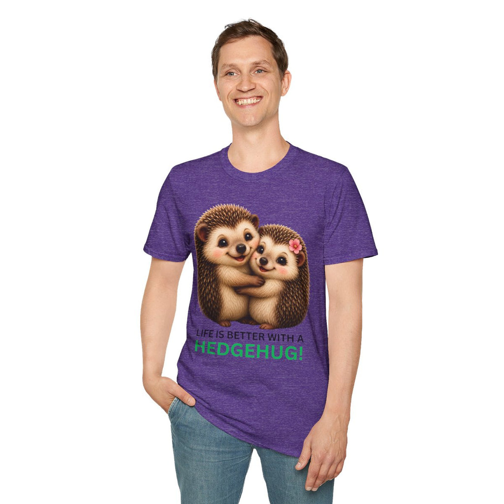 A man wearing a purple heathered graphic t-shirt with a cute hedgehog illustration and the text 'A LIFE IS BETTER WITH A HEDGEHUG!' printed on the front, paired with blue jeans against a plain white background.