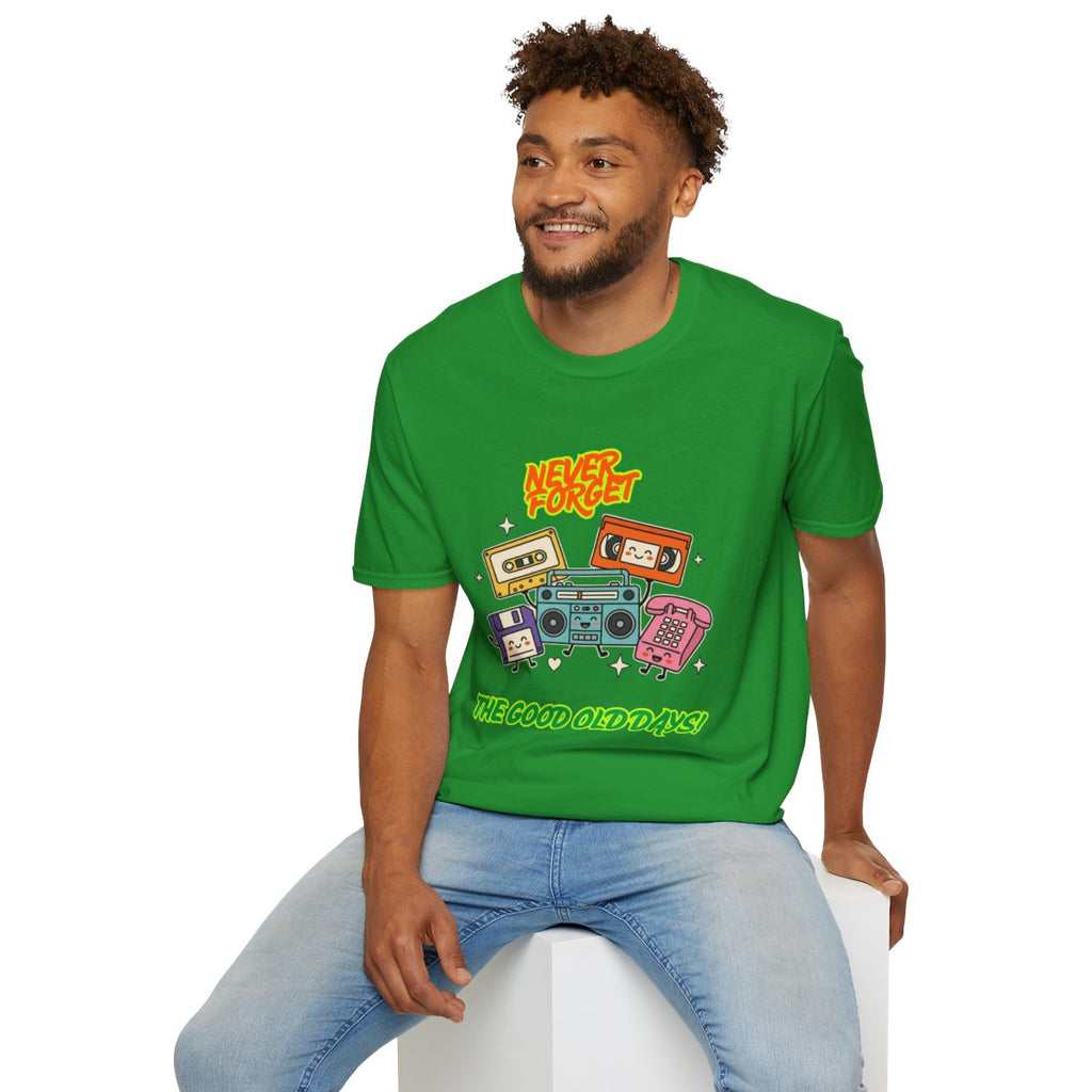 A man wearing a bright green graphic t-shirt with retro cassette tapes and the text 'HEY! THE GOOD OLD DAYS' sitting on a white block against a white background.