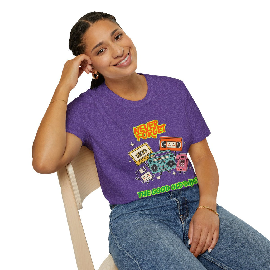 A woman wearing a purple graphic t-shirt with retro cassette tapes and the text 'NEVER FORGET' and 'THE GOOD OLD DAYS', paired with blue jeans, sitting on a light-colored wooden chair against a white background.