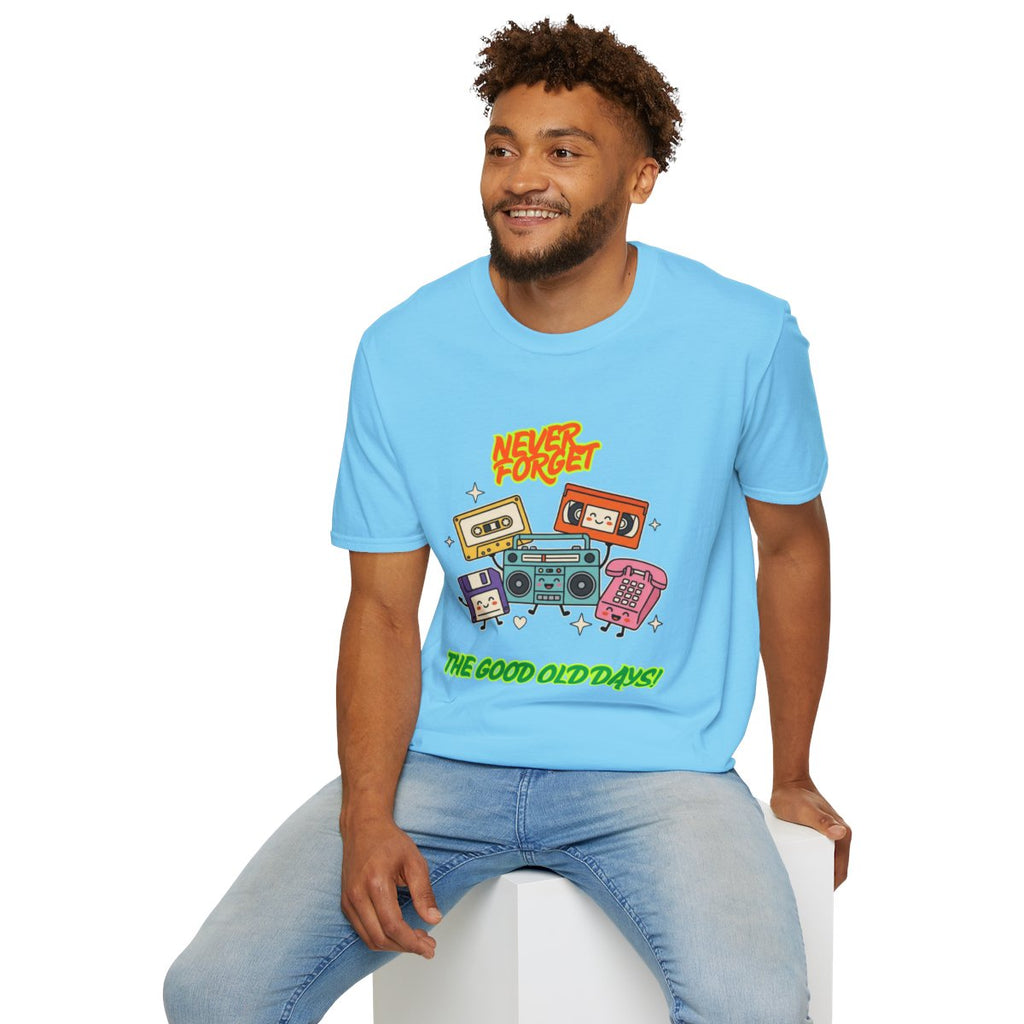 A man wearing a light blue graphic t-shirt with retro cassette tapes and the text 'Never Forget The Good Old Days!' sitting on a white block against a white background.
