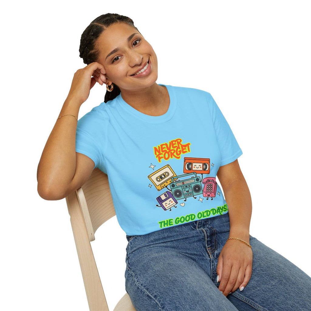 A woman sitting on a wooden chair wearing a light blue graphic t-shirt with retro cassette tapes and the text 'NEVER FORGET' and 'THE GOOD OLD DAYS'.