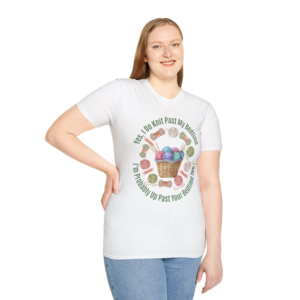 A woman modeling a white short-sleeve graphic T-shirt with a colorful illustration of knitting needles, yarn balls, and the text 'Yes I Do Knit Past My Bedtime I'll Probably Up Past Your Bedtime Too' on a plain white background.