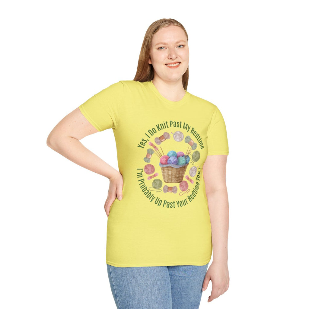 A woman modeling a light yellow graphic t-shirt with a circular design featuring knitting needles, yarn balls, and the text 'Yes I Do Knit Past My Bedtime. I'll Probably Up Past Your Bedtime' in a circular layout. She is wearing blue jeans against a plain white background.